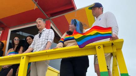 Close-up of Asm. Muratsuchi (speaking) and others on Pride Lifeguard Tower