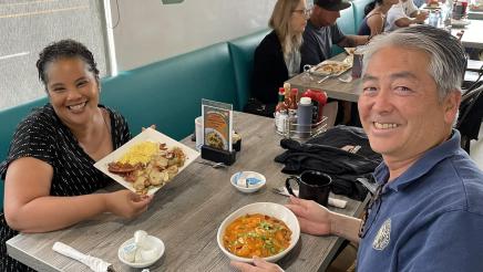 Asm. Muratsuchi with Councilwoman Lewis seated, having breakfast