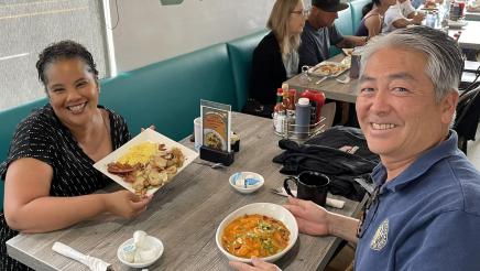 Asm. Muratsuchi with Councilwoman Lewis seated, having breakfast