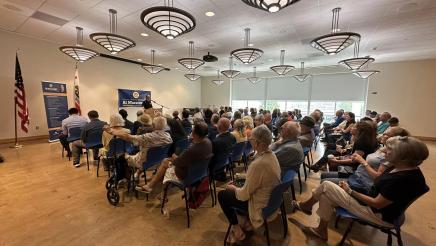 Wide view of many event attendees