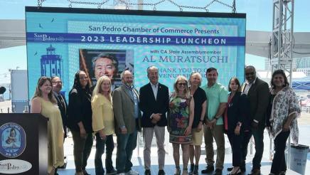Asm. Muratsuchi with Chamber of Commerce members, with large screen in background