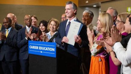 Asm. Muratsuchi with Gov. Newsom (at podium) and others