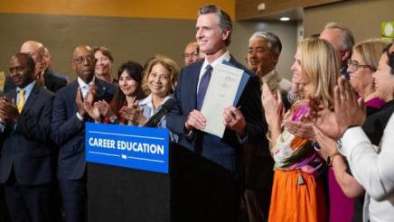 Asm. Muratsuchi with Gov. Newsom (at podium) and others