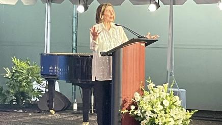 Nancy Pelosi at podium, speaking