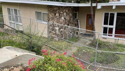 Home surrounded by fencing