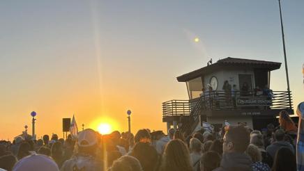 The sun setting over the gathered participants