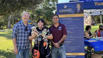 Asm. Muratsuchi, city councilmember and constituent holding two dogs