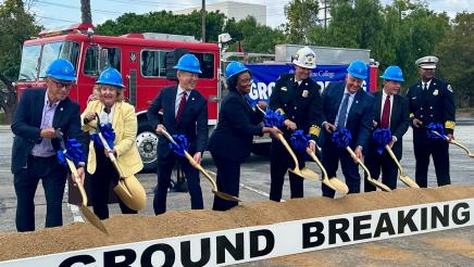 Asm. Muratsuchi and others with hard hats on, shoveling dirt during ceremony
