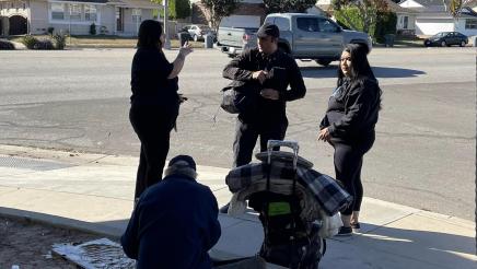 Homeless outreach coordinators speaking with homeless man