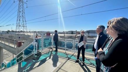 Asm. Muratsuchi listens on while tour guide speaks