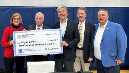 Asm. Muratsuchi and others holding up ceremonial check