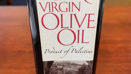 Close-up photo of bottle of olive oil on table