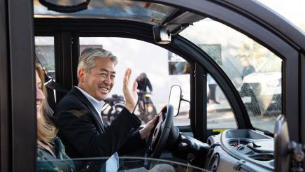 Asm. Muratsuchi waving as he drives electric vehicle