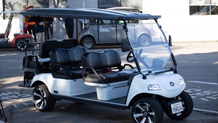 Electric golf cart parked in designated EV parking spot