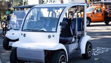 Small electric vehicle parked in designated EV parking spot