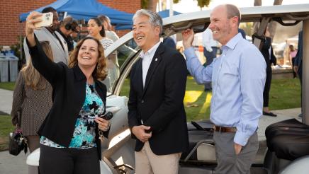 Asm. Muratsuchi taking photo with two attendees