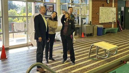 Asm. Muratsuchi and wife examining ceiling of indoor pool with YMCA staffers