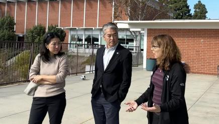 Asm. Muratsuchi and wife in conversation with YMCA staffer outside of building