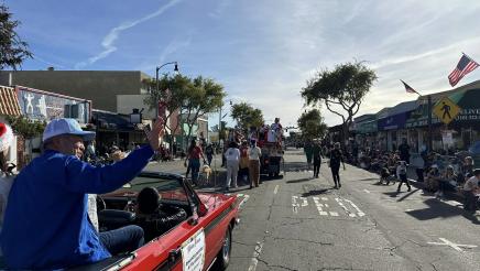 Asm. Muratsuchi waving to constituents from back seat of parade car