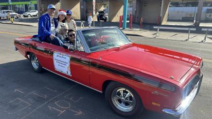 Asm. Muratsuchi and family sitting up in back seat of parade car