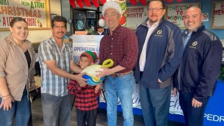 Asm. Muratsuchi with CA Water Service staffers and family receiving turkey