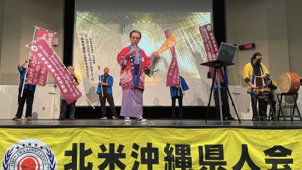 Group onstage, some holding banners
