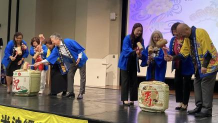 Asm. Muratsuchi and others onstage holding mallets, about to hit baskets