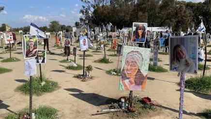 Multiple memorials featuring photos of victims at the site of the Nova music festival