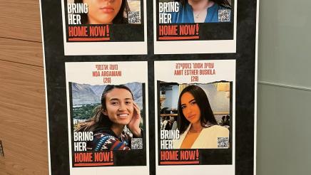 Poster on stand displaying four photos of kidnapping victims