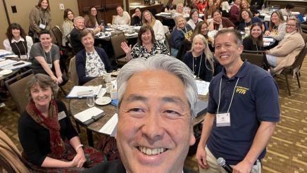 Asm. Muratsuchi taking selfie, with multiple event attendees in background