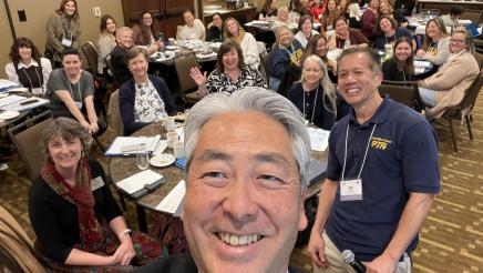 Asm. Muratsuchi taking selfie, with multiple event attendees in background