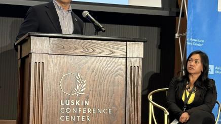 Asm. Muratsuchi onstage at podium, speaking