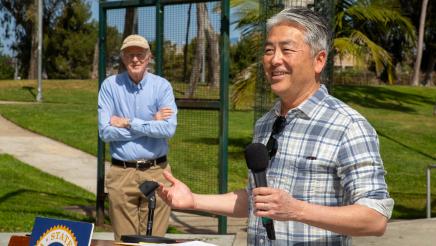 Actor Ed Begley Jr. listens on as Asm. Muratsuchi speaks from podium