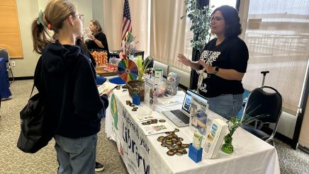 Booth staffer sharing information with constituent