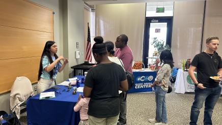 Booth staffer speaking with constituents
