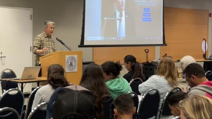 Asm. Muratsuchi at podium, speaking to audience