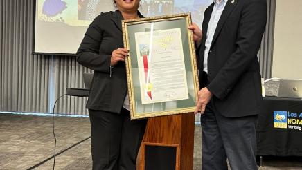 Asm. Muratsuchi presenting Woman of the Year award to Lila Omura