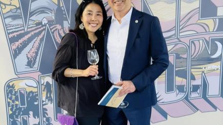 Asm. Muratsuchi and wife in front of Manhattan Wine Auction backdrop