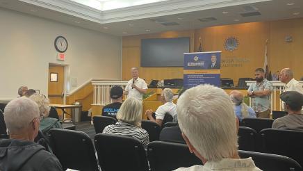 Asm. Muratsuchi at head of room, speaking to audience