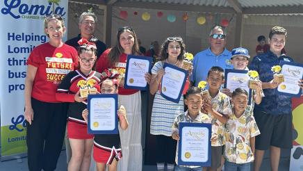 Group photo of Asm. Muratsuchi and Heidi Butzine with multiple youth awardees