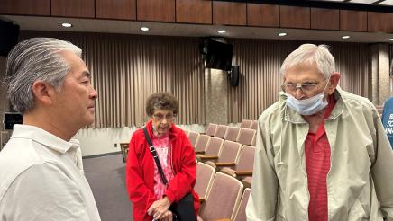 Asm. Muratsuchi speaking with two senior constituents, one wearing mask