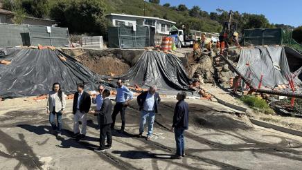 Asm. Muratsuchi and other officials within sunken landslide area