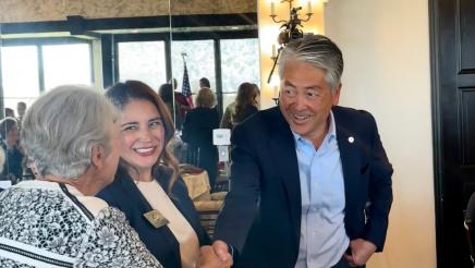 Asm. Muratsuchi shaking hands with one of the members at the event