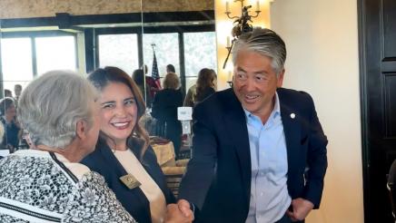 Asm. Muratsuchi shaking hands with one of the members at the event