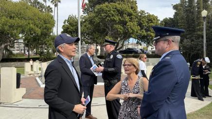 Asm. Muratsuchi speaking with two attendees