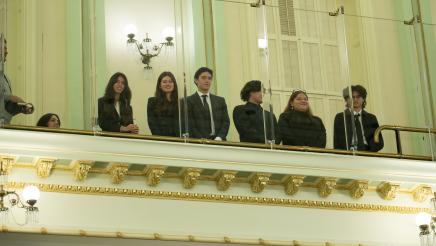 Delegation guests looking on from the balcony