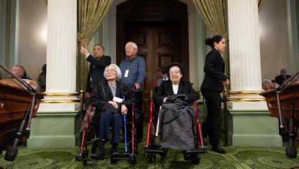 US concentration camp survivors in wheelchairs listening on