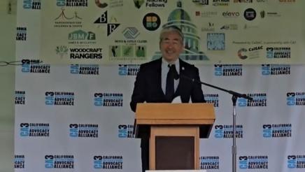 Asm. Muratsuchi onstage at podium, speaking