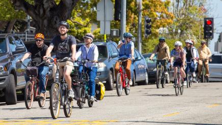 Ride participants biking down street