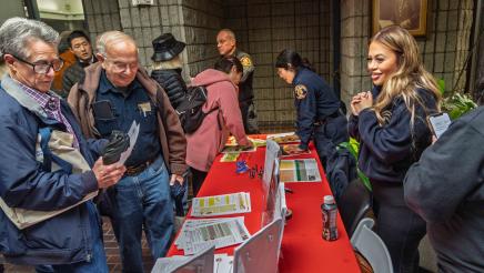 Fire department representatives at table sharing informative materials with attendees